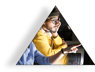 Side view portrait of several people working in dark office at night, focus on two colleagues using computer in foreground, copy space